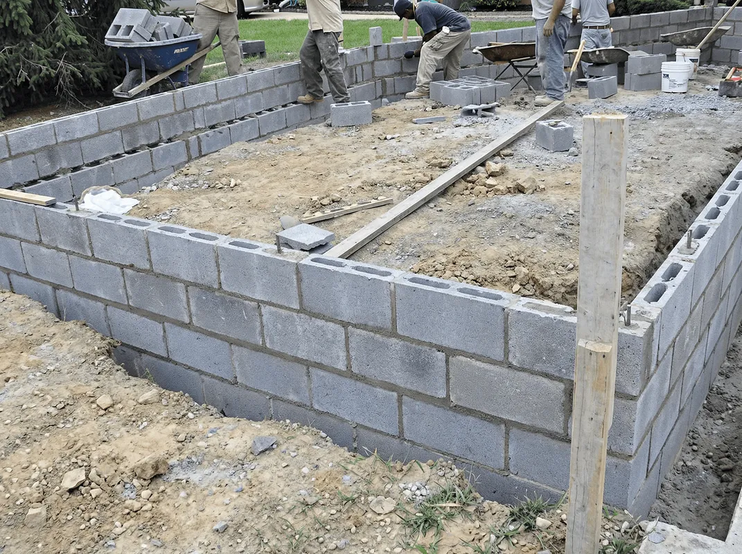 Professionals building a foundation with blocks in El Paso, TX