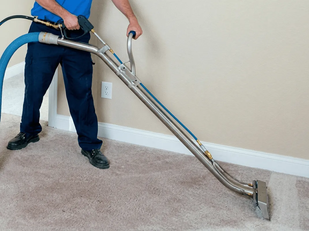Professional operating a liquid removal machine on a carpeted floor in El Paso, TX